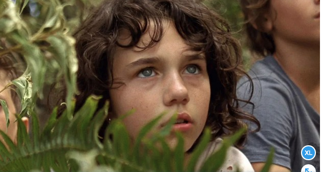 niña con ojos claros en un bosque